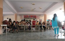 The school's large and spacious, well built and lit canteen. There are many tables and chairs for the students to enjoy their meals.